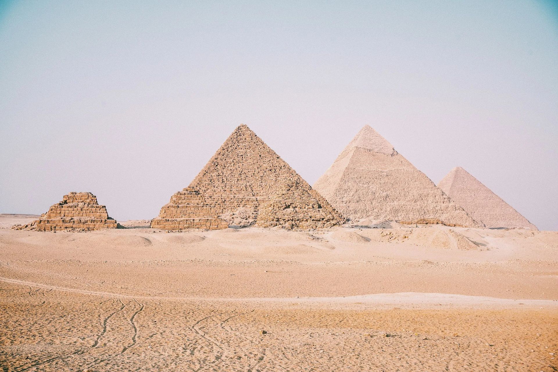 The three Pyramids of Giza on the plateau at golden hour